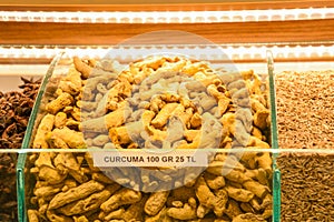 Dried turmeric roots and powder on countertop for selling in spice bazaar