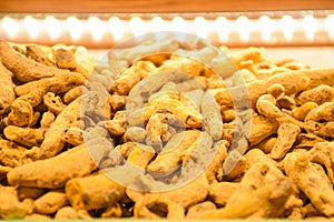 Dried turmeric roots and powder on countertop for selling in spice bazaar