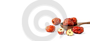 Dried unabi fruit or jujube with sliced in wood spoon of on white background. Chinese dried red date fruit.