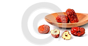 Dried unabi fruit or jujube with sliced in wood spoon of on white background. Chinese dried red date fruit.