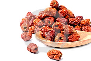Dried unabi fruit or jujube in wood bowl of on white background. Chinese dried red date fruit.