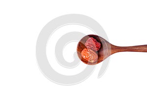 Dried unabi fruit or jujube in wood spoon of  on white background.