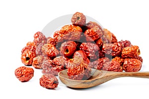 Dried unabi fruit or jujube in wood spoon of on white background. Chinese dried red date fruit.