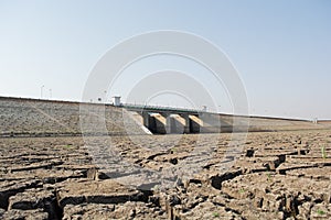 A dried up empty reservoir or dam during a summer heatwave, low rainfall and drought in north karnataka,India photo