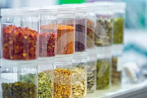 Dried vegetables in glass jars, onions, beets, carrots, pumpkin, bay leaf, banks on blurred background. Superfoods