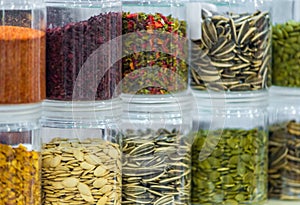 Dried vegetables in glass jars, onions, beets, carrots, pumpkin, bay leaf, banks on blurred background. Superfoods