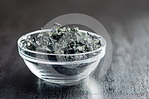 Dried wakame seaweed in bowl on black table