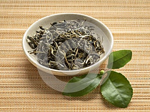 Dried white monkey tea leaves, Bai Mao Hou, close up in a bowl