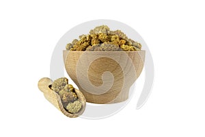 dried white mulberry fruit - latin Morus alba - in wooden bowl and scoop isolated on white background. Spices and food ingredient