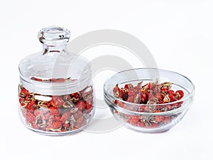 Dried wild rose in a glass jar, rosehips dried in a glass bowl