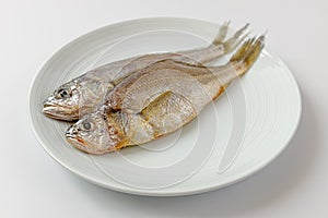 Dried yellow croaker on a white background