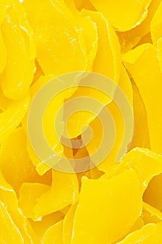 Dried yellow mangoes for proper nutrition scattering closeup top view