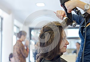 Dries hair in salon