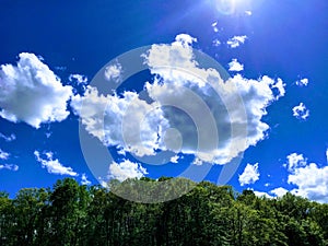 Drifting clouds on brilliant blue sky