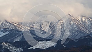 Drifting clouds on the snowy mountain around sunset at 20x speed