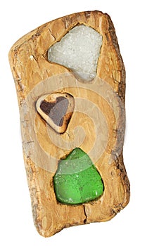 Driftwood decoration with sea glass isolated on a white background