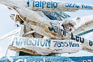 Driftwood directional sign showing cities and kilometers