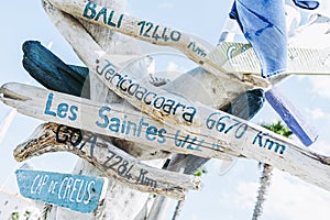 Driftwood directional sign showing cities and kilometers