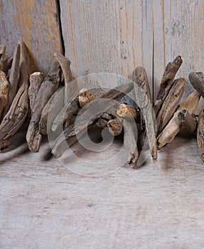 Driftwood and quail eggs on wooden background