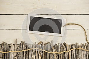 Driftwood and a tablet decorated on a white wood backbround