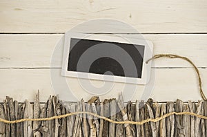 Driftwood and a tablet decorated on a white wood backbround photo