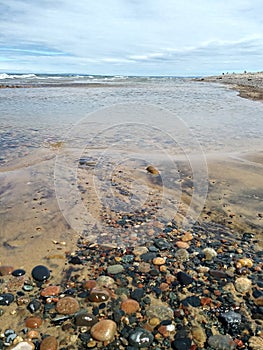 Driftwood Waves Pebbles Stones beach Rocks clear fresh Lake sea water bridge blue wet