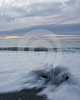 Driftwood, waves and sunset