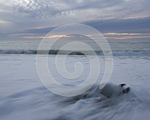 Driftwood, waves and susnet