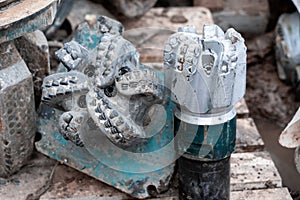 The drill bit, shot close-up with shallow depth of field.