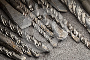 Drill bits for drilling concrete masonry or stone