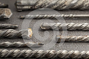 Drill bits for drilling concrete masonry or stone