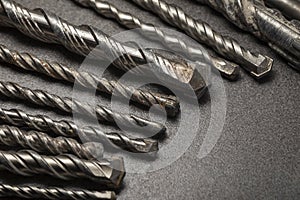 Drill bits for drilling concrete masonry or stone