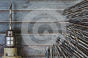 Drill and drill bits old metal background .