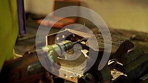 Drill drills metal in an artisan workshop