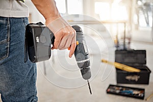 Drill, handyman and hand of a man at construction site for maintenance or carpenter work. Back of male engineer