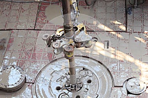 Drill pipe and rig tong on the rig floor while making up photo