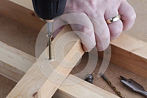 Drill screw and countersink wood on work bench