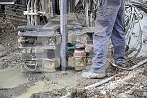 Driller working on industrial machinery for soil samples. 2