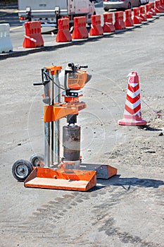 Drilling gasoline machine for cutting samples of asphalt concrete on the background of road repair