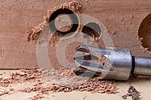 Drilling holes in the carpentry workshop with a special drill. Joinery accessories for repair work