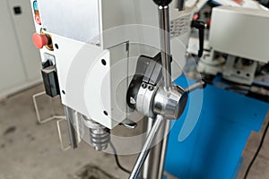 Drilling machine. New Industrial Iron drill in workshop interior. Tool store or exposition stand.