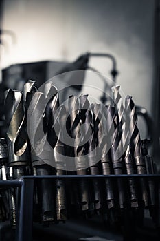 Drilling and milling equipment on a tools holder in a workshop.