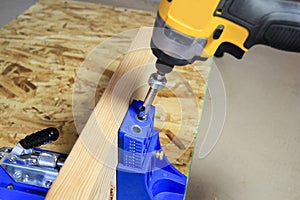 Drilling pocket holes into wood using a pocket hole jig photo
