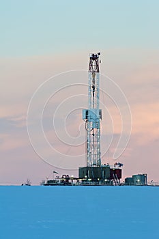 Drilling rig at dawn in winter