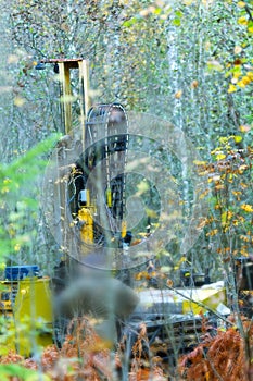Drilling rig drills soil in forest conditions