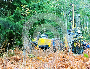 Drilling rig drills soil in forest conditions