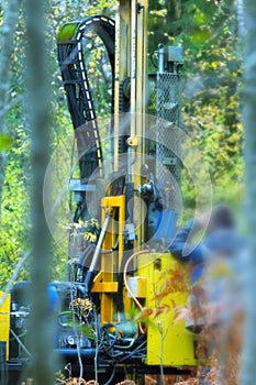 drilling rig drills soil in forest conditions