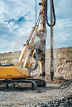 drilling rig machinery on highway construction site. Viaduct construction and bridge pillar details