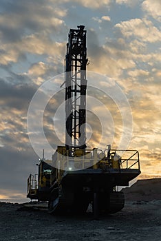 Drilling rig in an open pit.