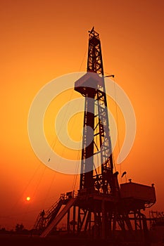 Drilling rig at sunset